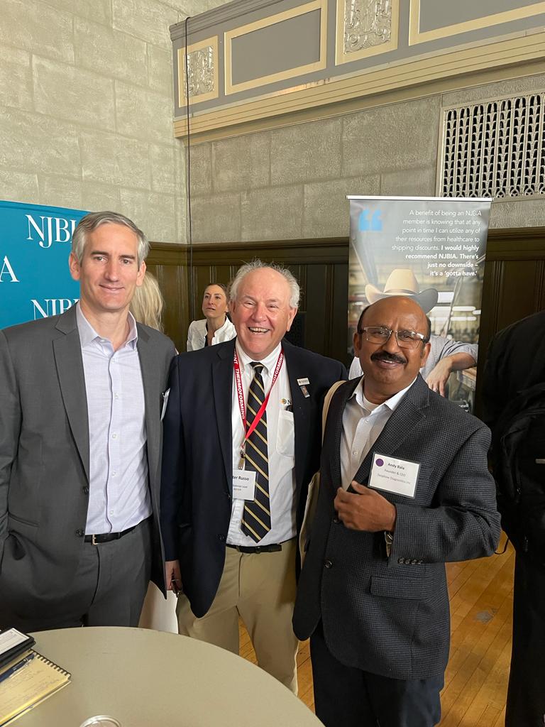 Three men taking a photo in an event